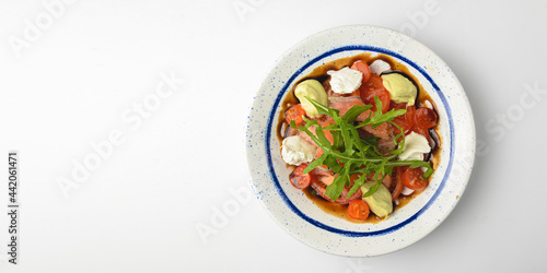 Tomato and salmon salad with cheese and spices. Traditional Italian cuisine, Italian concept.