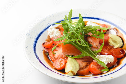 Tomato and salmon salad with cheese and spices. Traditional Italian cuisine  Italian concept.