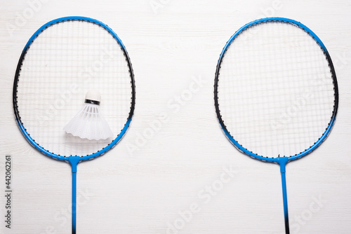 Rackets and shuttlecock on the white table background. Badminton concept background with copy space. © Natali