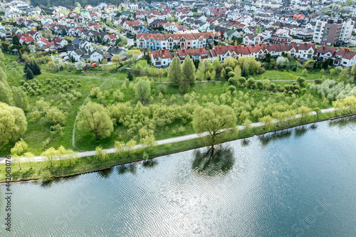 aerial view of summer cityscape with residential houses  green park and beautiful river