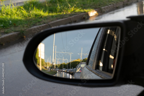 Looking in the side rear-view mirror in the day of rainy dreams