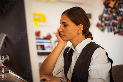 FBI female working agent in her office. Focus is on woman. Woman working on computer. photo