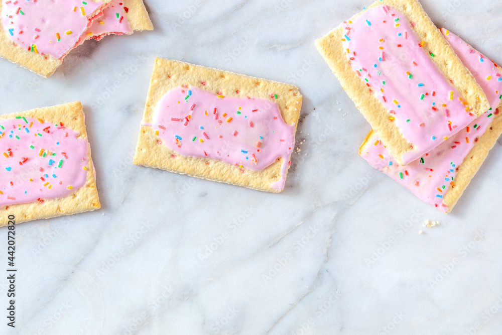 Vibrant pop tarts, shot from above on a marble background with a place for text Vibrant pop tarts, shot from above on a marble background with a place for text