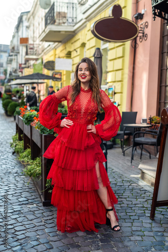 beautiful stylish brunette woman posing in red dress