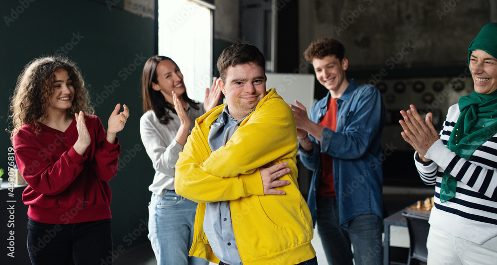 Fototapeta premium Down syndrome man with friends in community center, inclusivity and unity concept.