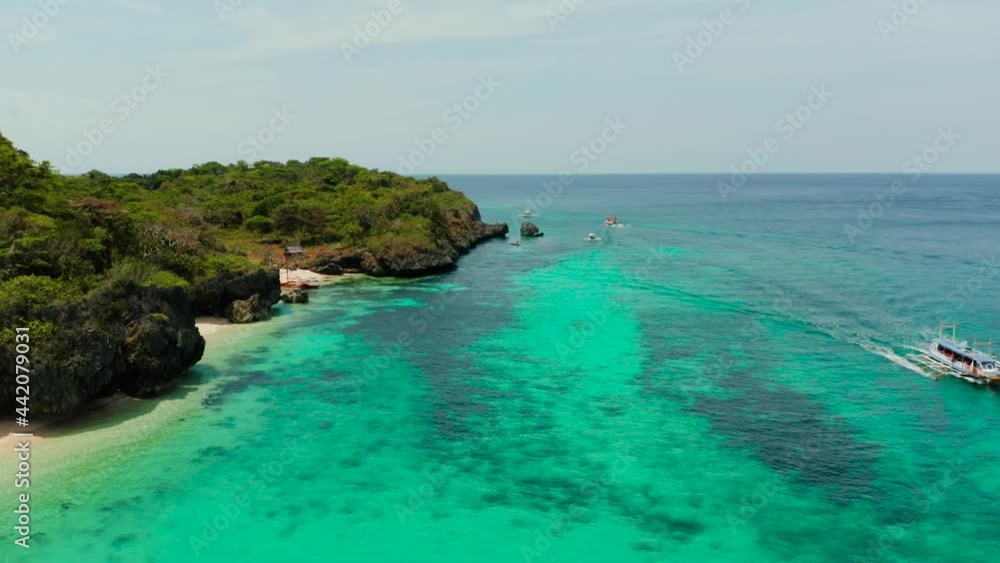 Sandy tropical beach with tourists and blue clear sea. Summer and travel vacation concept. Boracay, Philippines. Seascape with beach on tropical island. Puka shell beach Sandy tropical beach with tourists and blue clear sea. Summer and travel vacation concept. Boracay, Philippines. Seascape with beach on tropical island. Puka shell beach