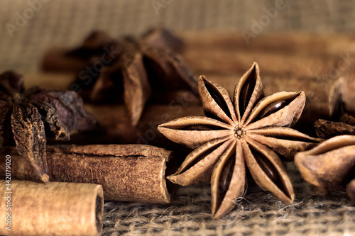 cinnamon sticks and star anise on burlap close-up. Photo. macro