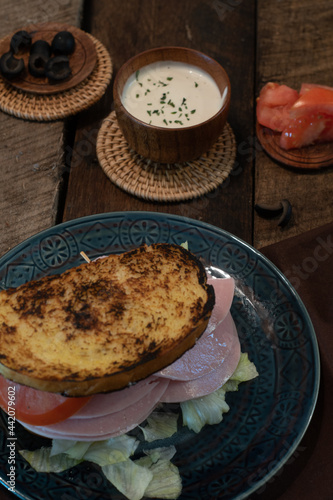 Turkey sandwich on toasted sourdough bread with ranch dressing.