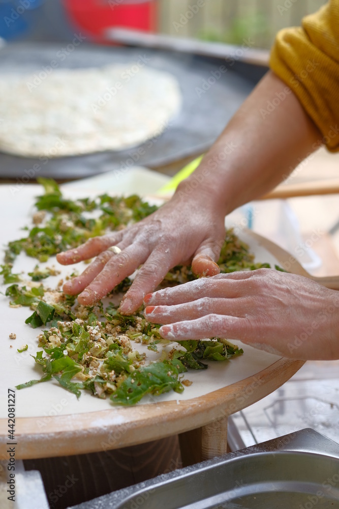Turkish woman prepares traditional dishes at home kitchen. Turkish woman prepares traditional dishes at home kitchen.