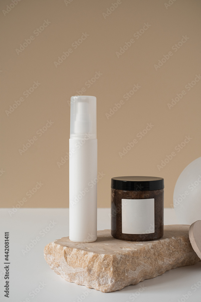 Blank spray bottle, body cream jar, marble stone on neutral pastel beige background. Aesthetic minimal beauty cosmetics composition with body care treatment. Organic natural spa therapy product Blank spray bottle, body cream jar, marble stone on neutral pastel beige background. Aesthetic minimal beauty cosmetics composition with body care treatment. Organic natural spa therapy product