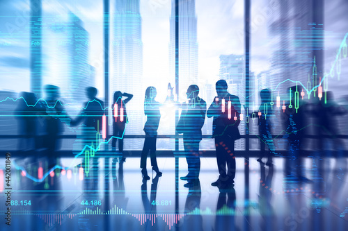 Teamwork and market concept. Group of successful businesspeople standing in blurry office interior with forex chart. Double exposure.