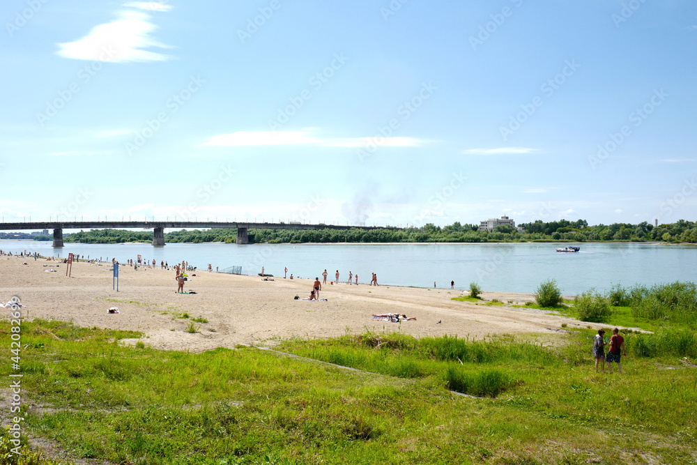 The central city beach on the banks of the Irtysh River overlooking the Leningradsky Bridge. Omsk, Siberia, June 27, 2021.