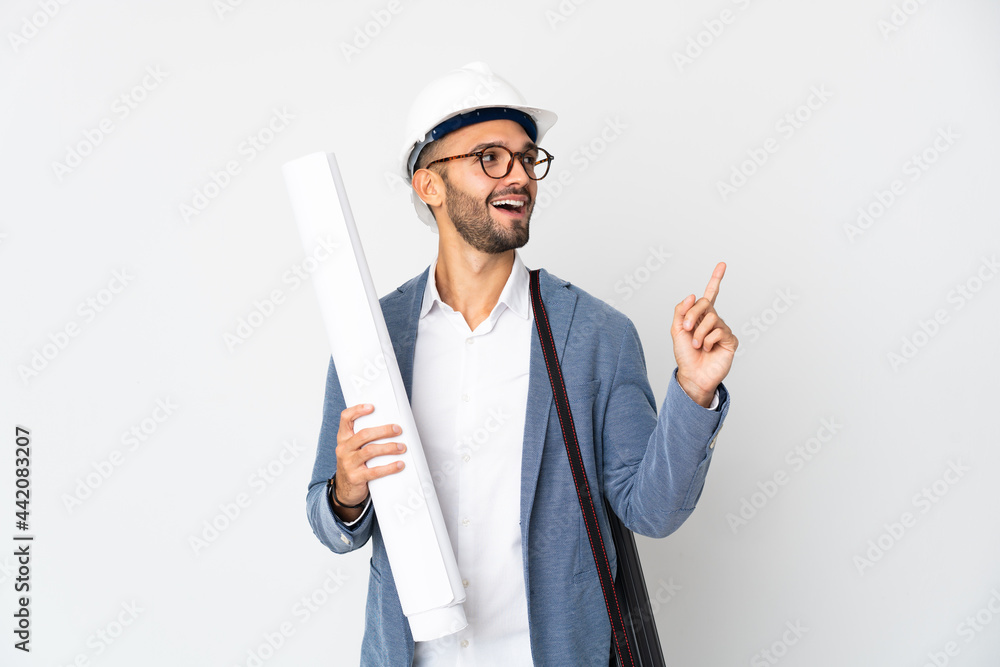 Young architect man with helmet and holding blueprints isolated on white background pointing up a great idea Young architect man with helmet and holding blueprints isolated on white background pointing up a great idea