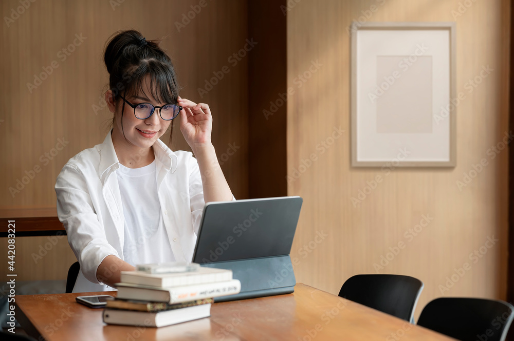 Beautiful woman working on computer with happiness at her office. Beautiful woman working on computer with happiness at her office.