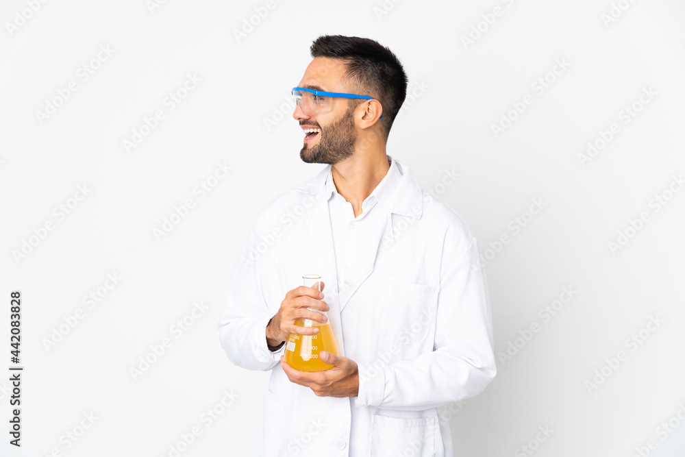 Young scientific man isolated on white background looking side