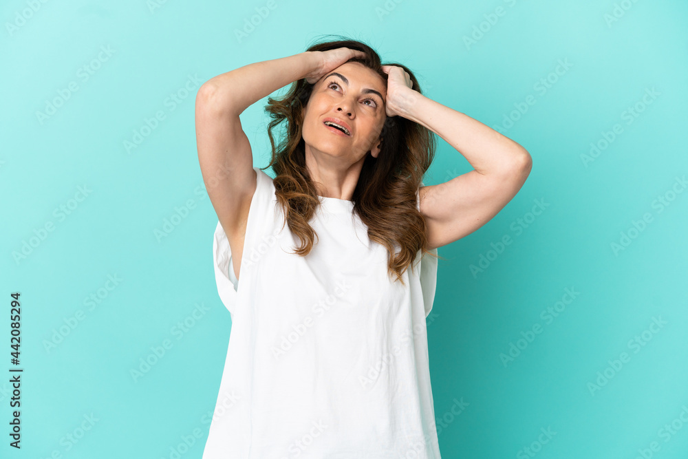 Middle aged caucasian woman isolated on blue background laughing Middle aged caucasian woman isolated on blue background laughing