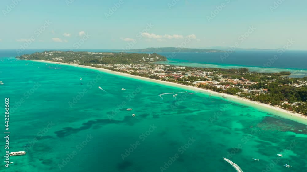 Tropical white sand beach, hotels near the blue lagoon and corall reef. aerial view, Boracay, Philippines. Seascape with beach on tropical island. Summer and travel vacation concept. Tropical white sand beach, hotels near the blue lagoon and corall reef. aerial view, Boracay, Philippines. Seascape with beach on tropical island. Summer and travel vacation concept.