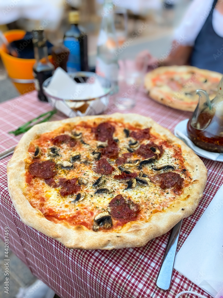 Spicy pizza with salami and mushrooms, Puerto Andratx, Mallorca, Spain Spicy pizza with salami and mushrooms, Puerto Andratx, Mallorca, Spain