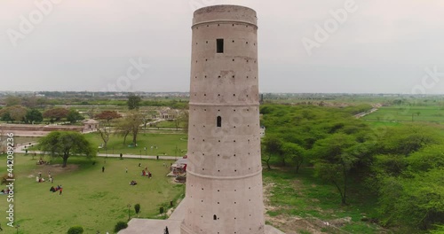Tracking Aerial Shot Of Hiran Minar Tower, Tourists Visit Famous Landmark In Pakistan photo
