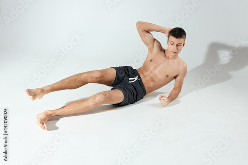 man doing exercises lying on the floor indoors morning exercises