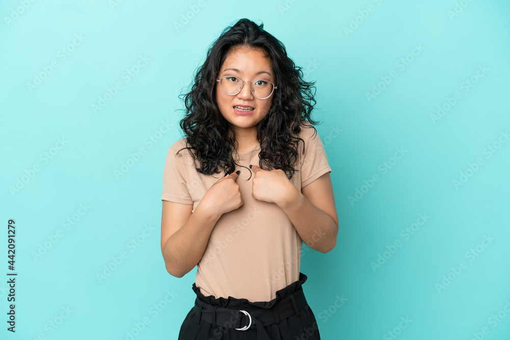 Young asian woman isolated on blue background with surprise facial expression Young asian woman isolated on blue background with surprise facial expression