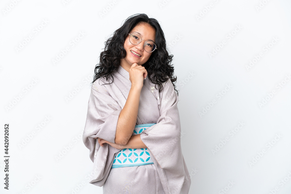 Young asian woman wearing kimono isolated on white background with glasses and smiling Young asian woman wearing kimono isolated on white background with glasses and smiling