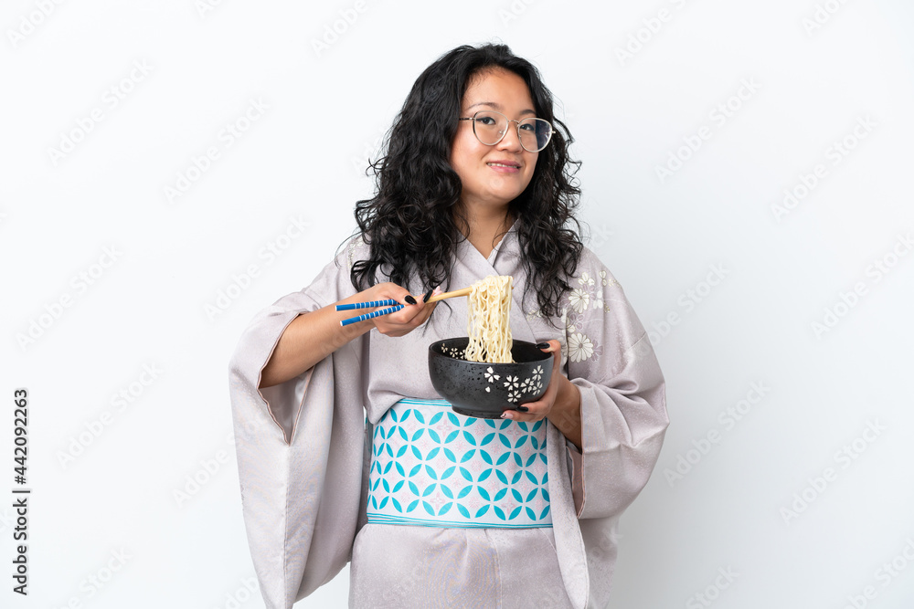 Young asian woman wearing kimono isolated on white background holding a bowl of noodles with chopsticks Young asian woman wearing kimono isolated on white background holding a bowl of noodles with chopsticks