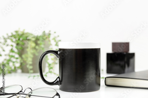 Black dad coffee mug mockup on workplace. Cup mock up for male style design 