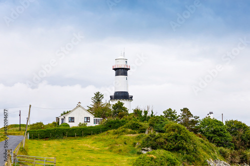 Lighthouse on Inishowen peninsula in North Ireland. Beautiful Wild Atlantic Way with typical irish landscapes, coastline and cliffs.