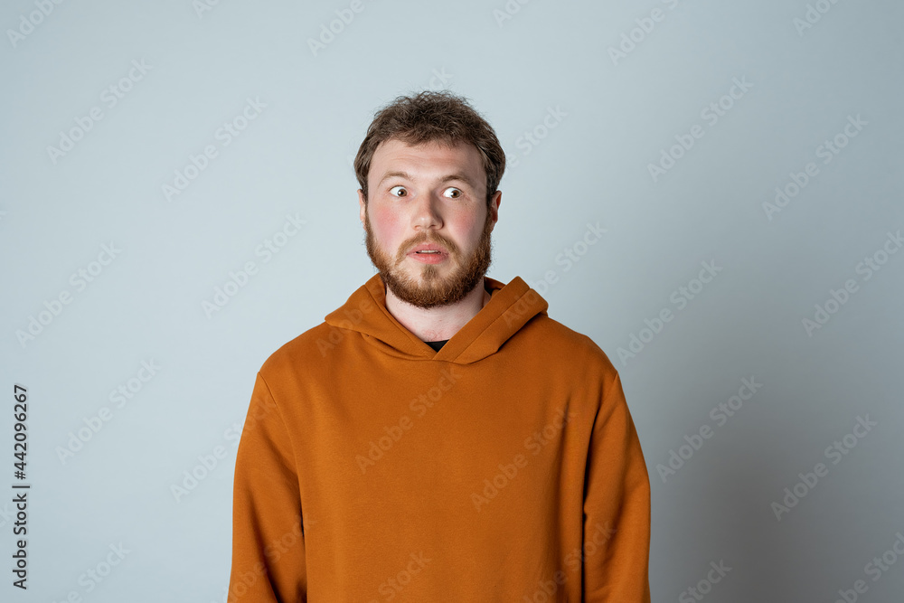 Portrait of shocked and concerned bearded modern young man, looking at camera alarmed, reacting to something bad Portrait of shocked and concerned bearded modern young man, looking at camera alarmed, reacting to something bad