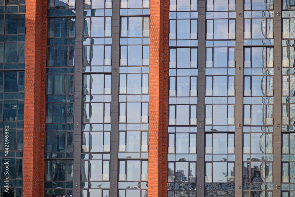 A fragment of the facade of a modern building on a summer evening A fragment of the facade of a modern building on a summer evening