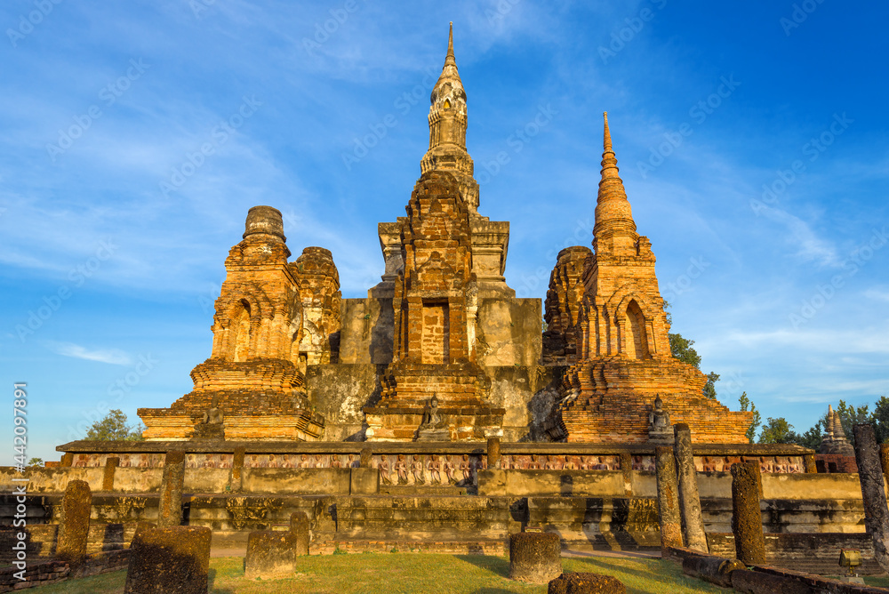 Ruins of the ancient Buddhist temple of Wat Mahathat in the light of the evening sun. Old Sukhothai, Thailand Ruins of the ancient Buddhist temple of Wat Mahathat in the light of the evening sun. Old Sukhothai, Thailand