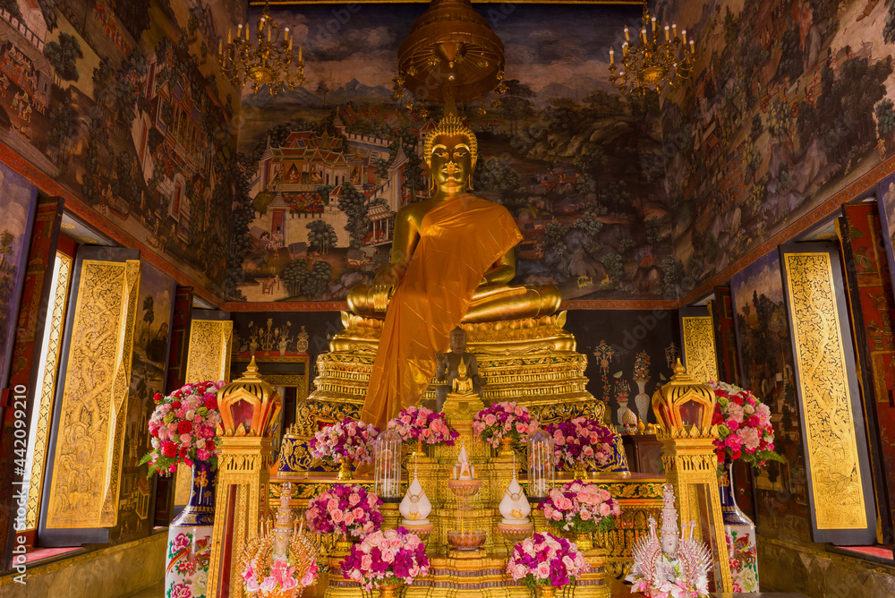 Altar with a sculpture of a seated Buddha in one of the bots of the Wat Bowonniwet Buddhist temple. Bangkok thailand