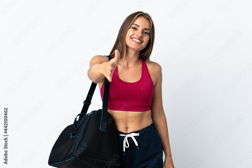 Young sport Uruguayan woman with sport bag isolated on white background shaking hands for closing a good deal