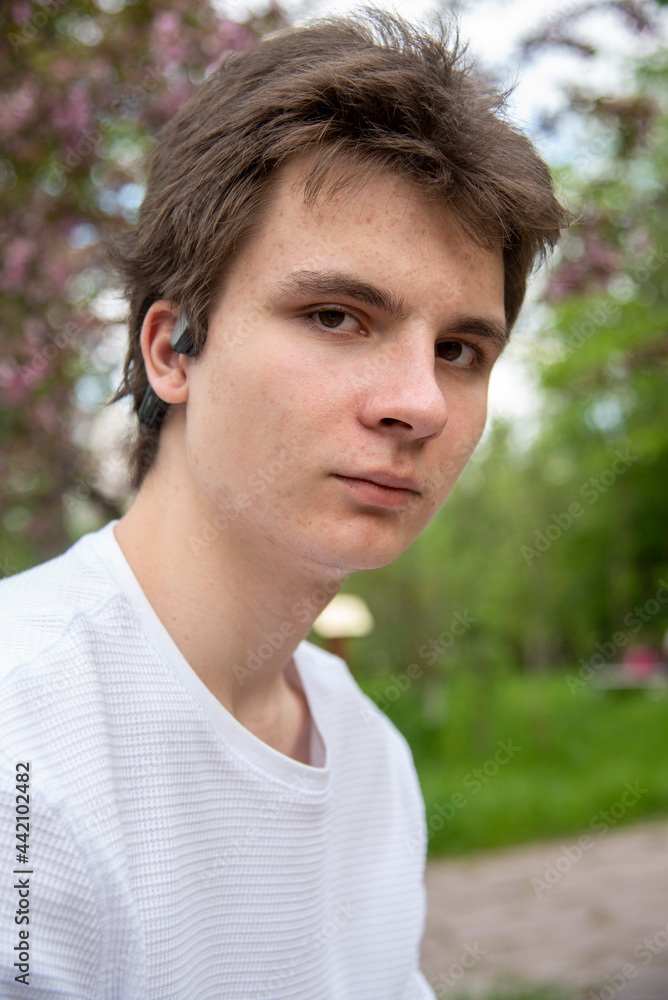 Portrait of an 18-year-old boy against the background of spring nature. Portrait of an 18-year-old boy against the background of spring nature.