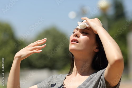 Asian woman drying sweat in a warm summer day photo