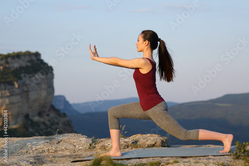 Asian woman practicing tai chi exercise outdoors photo