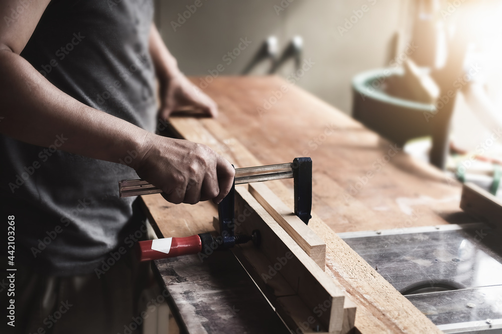 Woodworking operators are decorating pieces of wood to assemble and build wooden tables for customer Woodworking operators are decorating pieces of wood to assemble and build wooden tables for customer