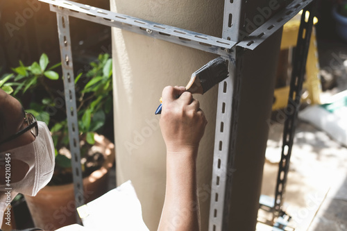 do it yourself concept, Craftsmen use anti-rust paint to paint old iron parts. Make a shelf on your free weekend