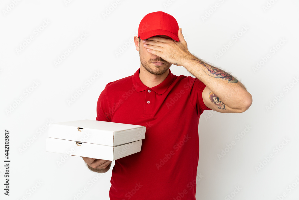 pizza delivery man with work uniform picking up pizza boxes over isolated white wall covering eyes by hands. Do not want to see something pizza delivery man with work uniform picking up pizza boxes over isolated white wall covering eyes by hands. Do not want to see something