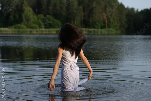 Fototapeta Naklejka Na Ścianę i Meble -  Young woman in white dress in the lake