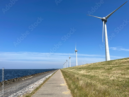 Windmills on a dike at the Noordoostpolder