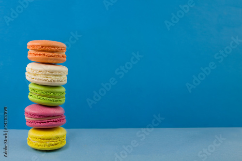 Multicolored macaroons on a blue background