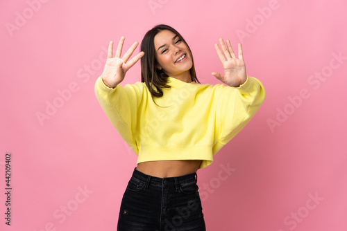 Teenager girl isolated on pink background counting nine with fingers