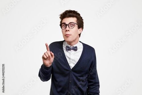 Clever nerdy man pointing up