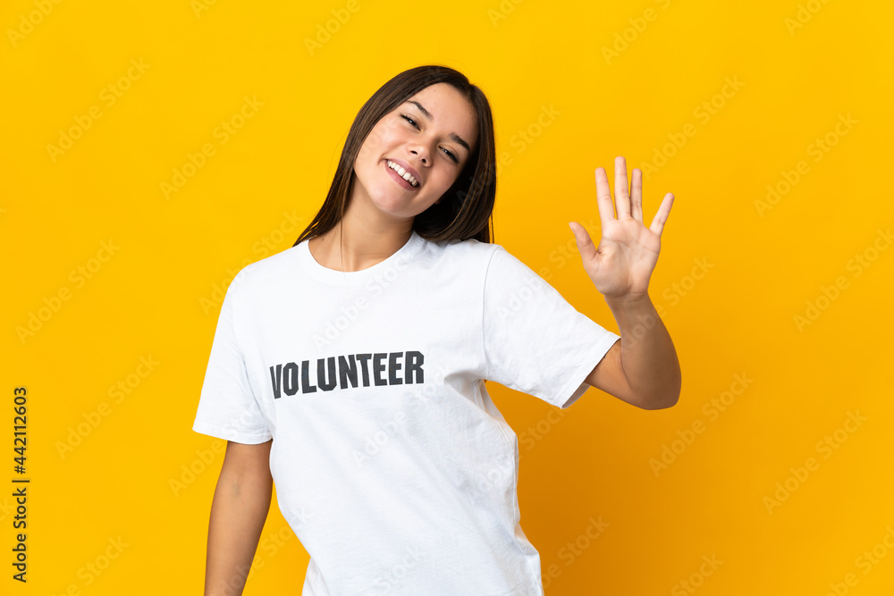 Teenager volunteer girl counting five with fingers Teenager volunteer girl counting five with fingers