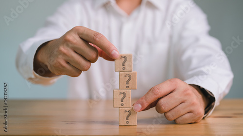 Obraz na plátne Hands of businessman Choosing Question Mark Block, problem management, Problem solving, Fixer, prioritization
