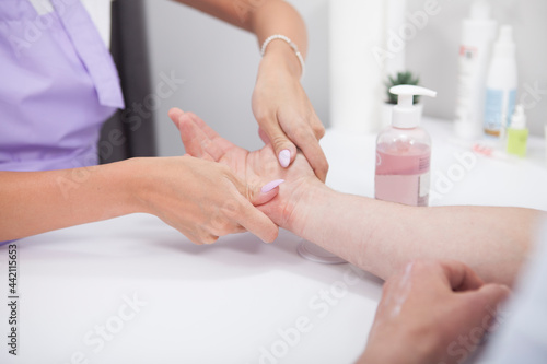 Cropped shot of unrecognizable man having his hands massaged by manicurist