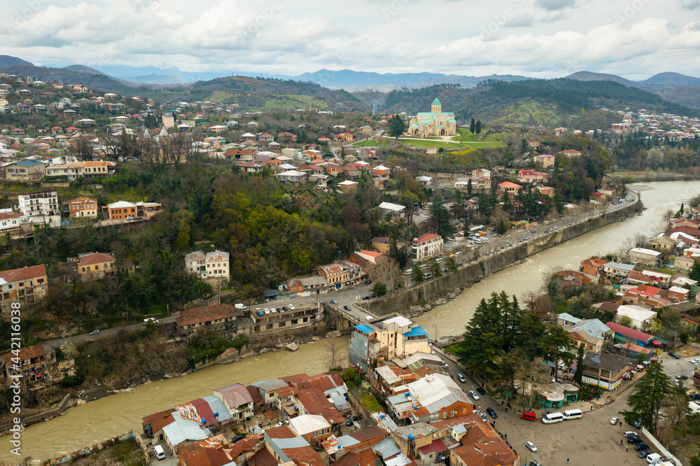 View from drone of historical districts of old Georgian city of Kutaisi on both sides of Rioni river with rebuilt 