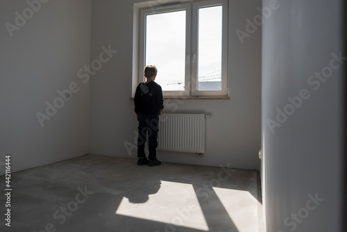 Happy young boy in his new empty room in the new flat © Dziurek